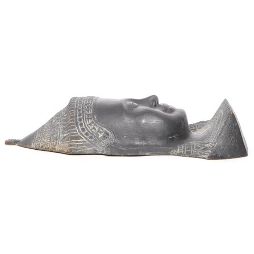 249 - A 20th Century cast ebonised brass Khmer Cambodian Buddha deity wall face mask, with detailed facial... 