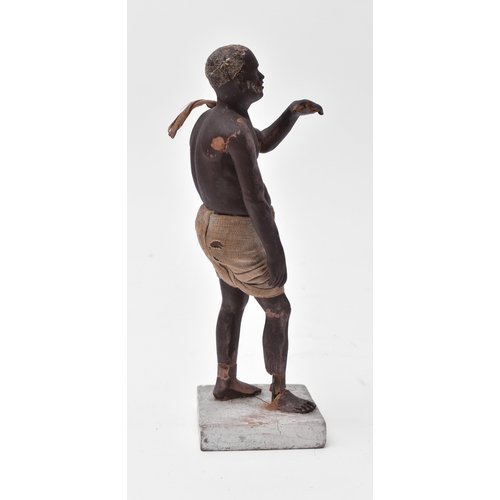 418 - A mid to late 19th century Indian Krishnanagar clay doll. Depicts a man with cloth clothing raised o... 