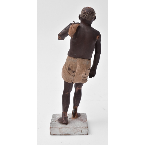 418 - A mid to late 19th century Indian Krishnanagar clay doll. Depicts a man with cloth clothing raised o... 