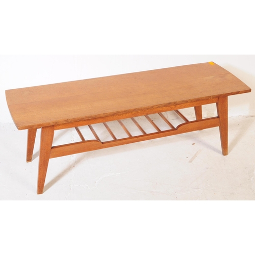 581 - British Modern Design - A mid 20th century circa 1960s teak Long John coffee table having shaped top... 