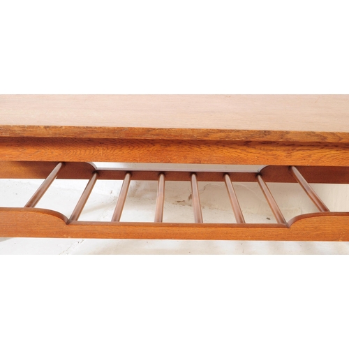 581 - British Modern Design - A mid 20th century circa 1960s teak Long John coffee table having shaped top... 