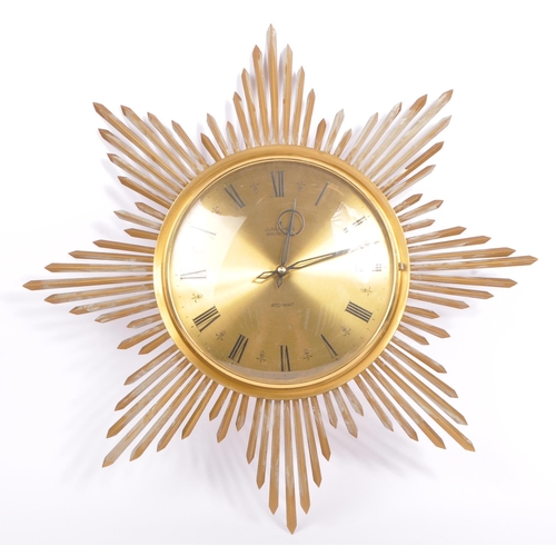 A vintage Ato Mat sunburst wall clock by Junghans Germany. Of