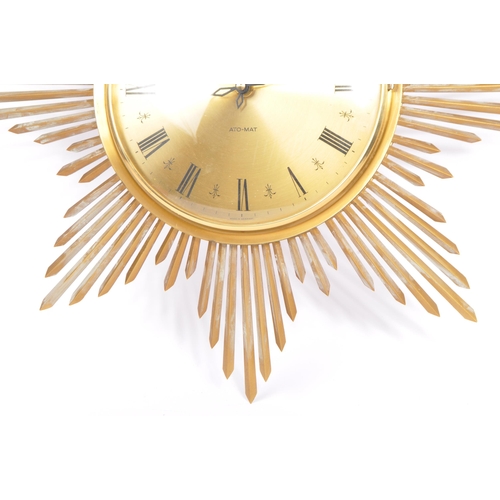 A vintage Ato Mat sunburst wall clock by Junghans Germany. Of