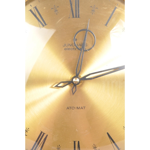 A vintage Ato Mat sunburst wall clock by Junghans Germany. Of