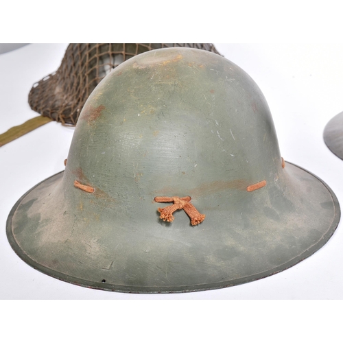 144 - A collection of WWII Second World War and later British Military helmets comprising; x2 Civil Defenc... 