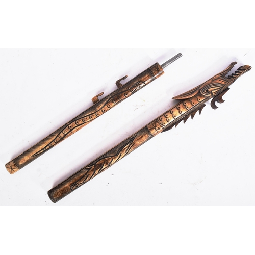 193 - An early 20th Century Indonesian blow pipe dart. Bone construction carved into the shape a of a myth... 