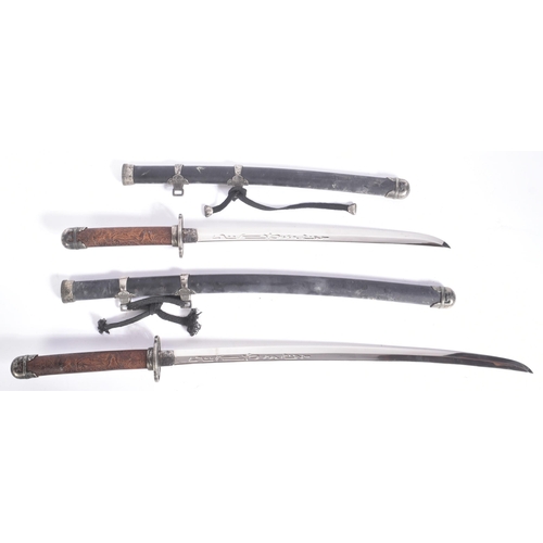 239 - A vintage Japanese Samurai Katana sword and a smaller matching Wakizashi. Each sword having a carved... 