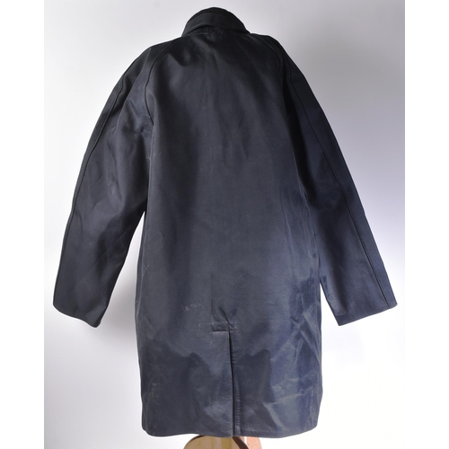 392 - A vintage British Railways double texture waterproof Mackintosh coat with double arrow buttons. Make... 