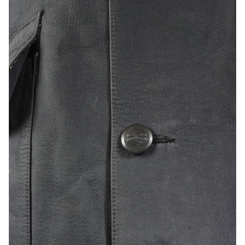 392 - A vintage British Railways double texture waterproof Mackintosh coat with double arrow buttons. Make... 