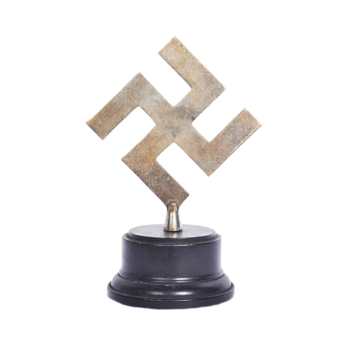 396 - A WWII Second World War Third Reich Nazi German trophy. Metal Swastika mounted onto a stepped circul... 