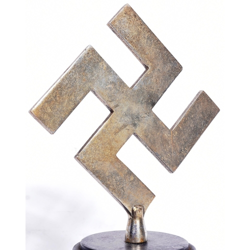 396 - A WWII Second World War Third Reich Nazi German trophy. Metal Swastika mounted onto a stepped circul... 