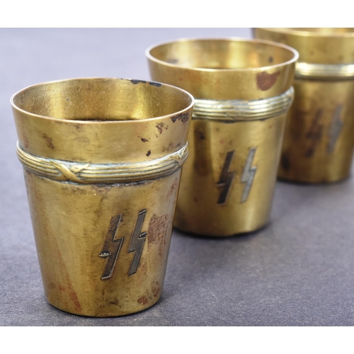 73 - A set of x6 WWII Second World War German Waffen SS Schnapps cups. Brass with engraved SS runes and r... 