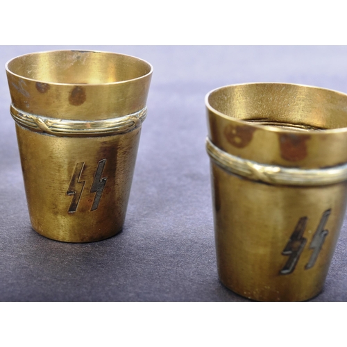 73 - A set of x6 WWII Second World War German Waffen SS Schnapps cups. Brass with engraved SS runes and r... 