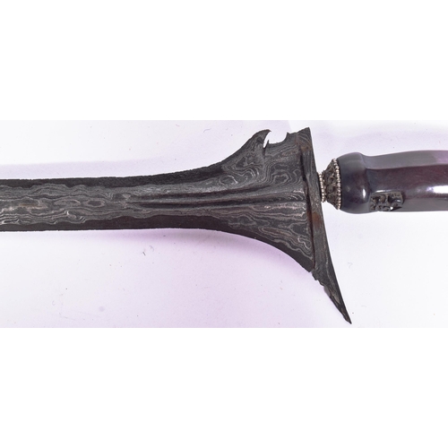 81 - An early 20th Century Malayan Kris / Keris dagger. Carved wooden hilt, blade with pamor blade housed... 