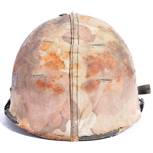 86 - A Vietnam War era US United States M1 steel combat helmet with camo cover. Swivel bale example with ... 