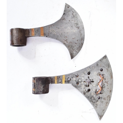 94 - Two North Indian tribal axe heads. Typical form with crescent shaped heads, one with pierced geometr... 