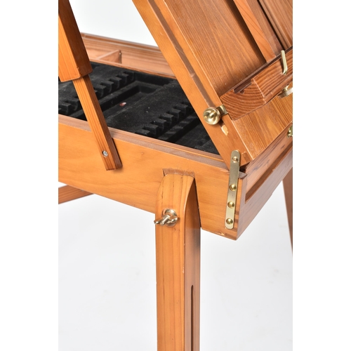 194 - A vintage 20th century folding collapsing architect's board / easel. The board raised on tapering su... 