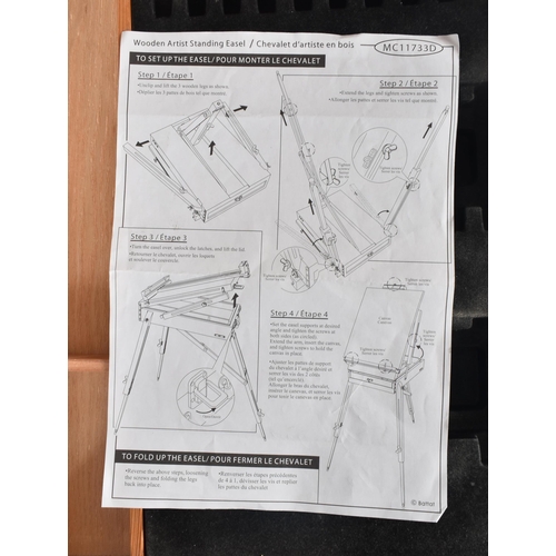 194 - A vintage 20th century folding collapsing architect's board / easel. The board raised on tapering su... 