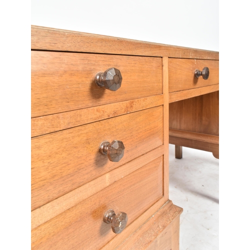 25 - Gordon Russell - A vintage 20th century 1940s solid walnut writing table desk. The desk having a cen... 