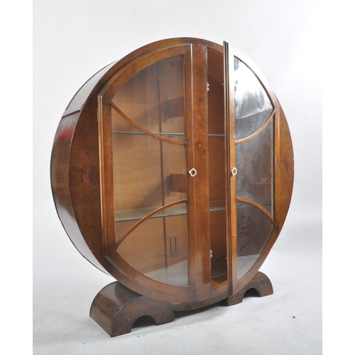 40 - A vintage 20th century 1930's Art Deco walnut display cabinet vitrine of circular form. The cabinet ... 