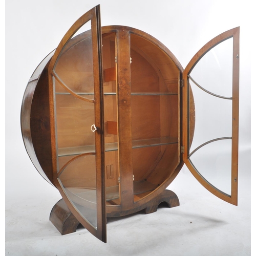 40 - A vintage 20th century 1930's Art Deco walnut display cabinet vitrine of circular form. The cabinet ... 