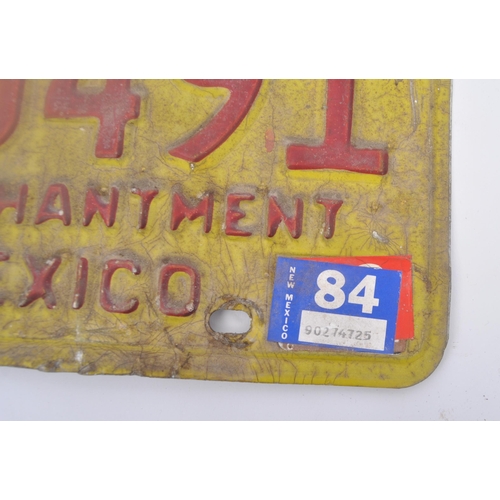 603 - A mixed selection of vintage American car number plates. The plates of pressed metal construction co... 