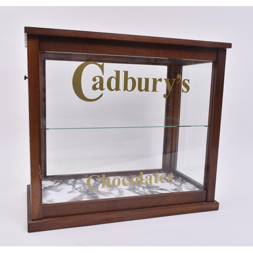 690 - A vintage 20th century upcycled oak cased cabinet with Cadbury's Chocolates advertising to the front... 