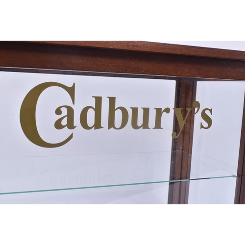 690 - A vintage 20th century upcycled oak cased cabinet with Cadbury's Chocolates advertising to the front... 