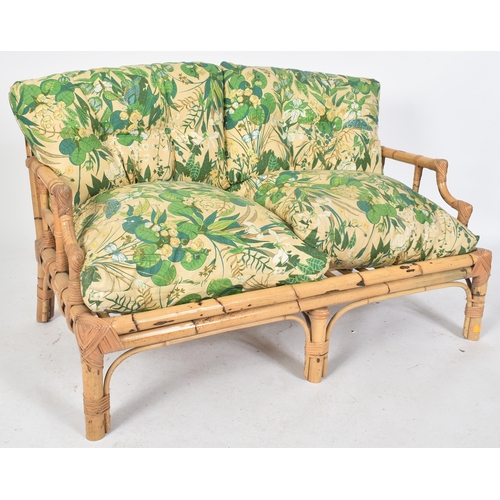 72 - A retro mid century bamboo framed two seater sofa settee. The sofa having a bamboo and wicker woven ... 