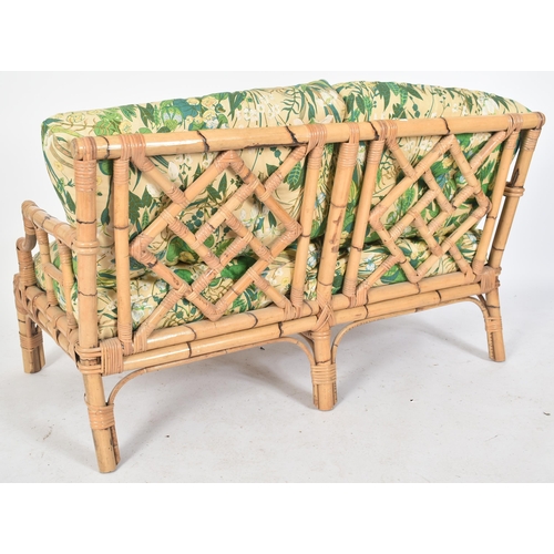 72 - A retro mid century bamboo framed two seater sofa settee. The sofa having a bamboo and wicker woven ... 