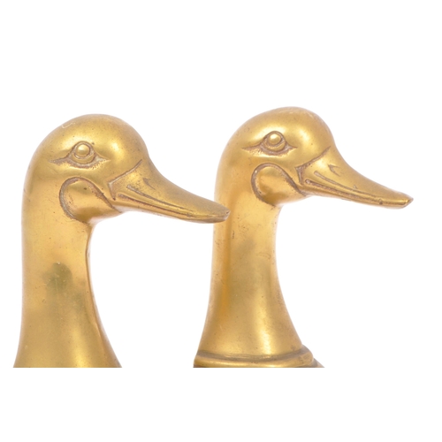244 - A vintage 20th century brass bookends in the form of duck heads / busts. Measures approx. 16cm tall.