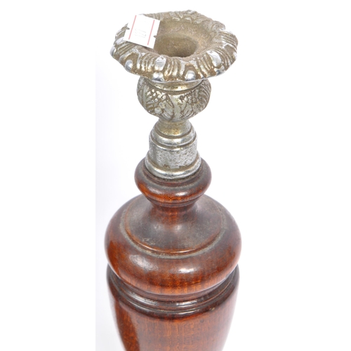 247 - A pair of early 20th century turned wood and silver candlesticks. The candlesticks having ornate sil... 