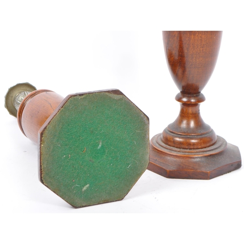 247 - A pair of early 20th century turned wood and silver candlesticks. The candlesticks having ornate sil... 