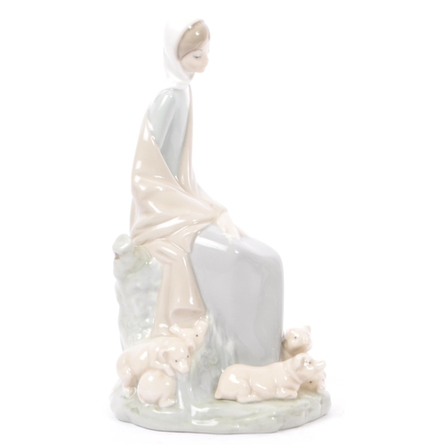 89 - Lladro - Nao - A collection of four late 20th century porcelain tableware figurines. To include a ba... 
