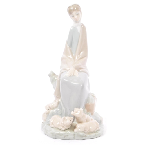 89 - Lladro - Nao - A collection of four late 20th century porcelain tableware figurines. To include a ba... 