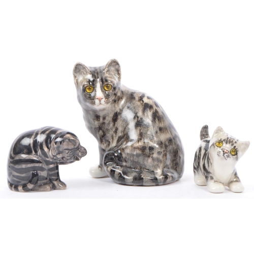 94 - A collection of vintage 20th century studio art pottery cats. In the form of tabby cats with two kit... 