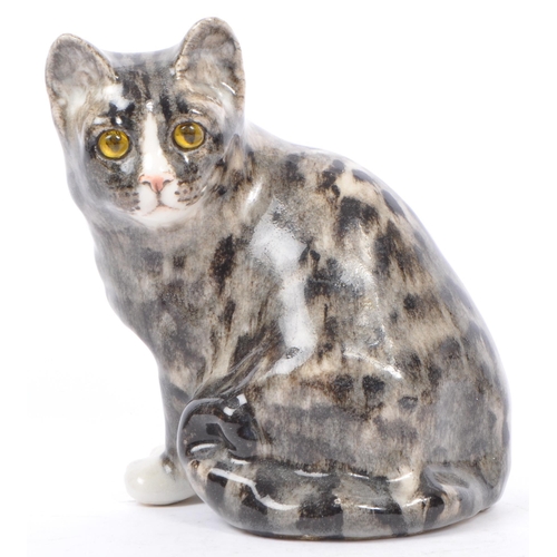 94 - A collection of vintage 20th century studio art pottery cats. In the form of tabby cats with two kit... 
