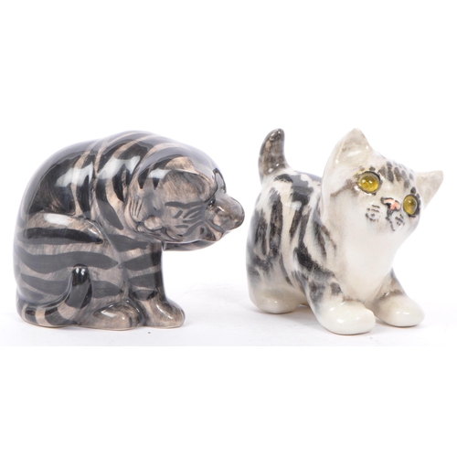 94 - A collection of vintage 20th century studio art pottery cats. In the form of tabby cats with two kit... 