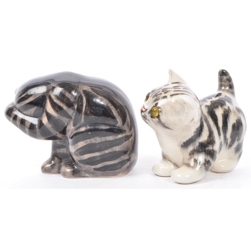 94 - A collection of vintage 20th century studio art pottery cats. In the form of tabby cats with two kit... 