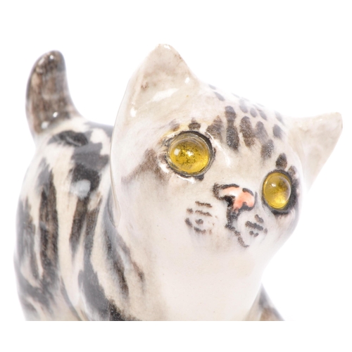94 - A collection of vintage 20th century studio art pottery cats. In the form of tabby cats with two kit... 