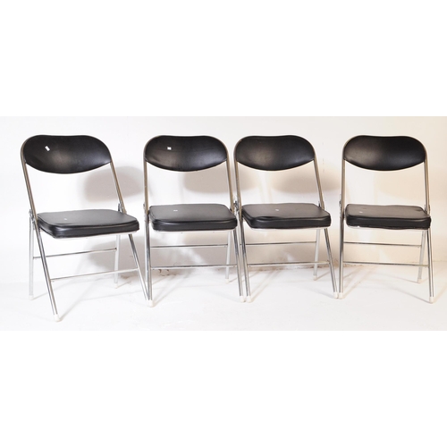 606 - A collection of four mid Century folding chairs constructed from a tubular chromed metal with black ... 