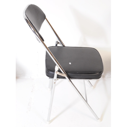 606 - A collection of four mid Century folding chairs constructed from a tubular chromed metal with black ... 
