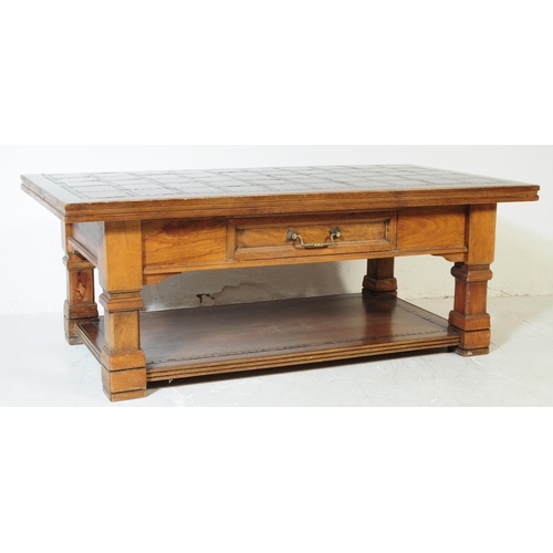607 - A vintage 20th century solid pine and oak coffee table. Of rectangular form with mosaic style tiles ... 