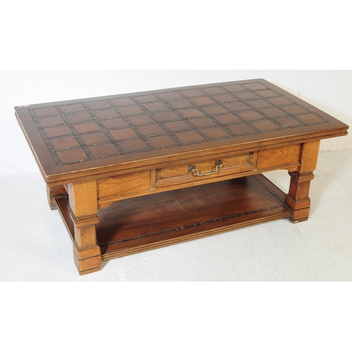 607 - A vintage 20th century solid pine and oak coffee table. Of rectangular form with mosaic style tiles ... 
