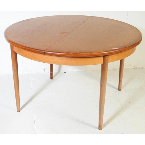 613 - G Plan - A mid 20th century G-Plan teak extending dining table and chairs. The table being of circul... 