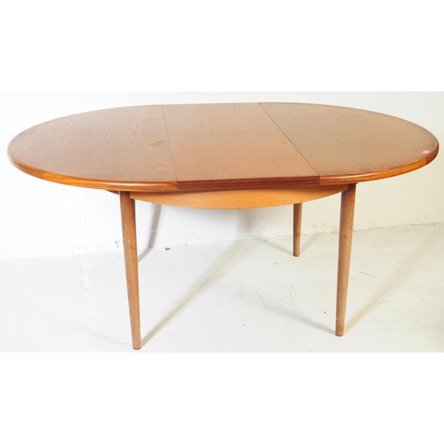 613 - G Plan - A mid 20th century G-Plan teak extending dining table and chairs. The table being of circul... 