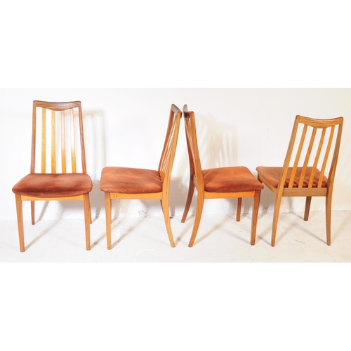 613 - G Plan - A mid 20th century G-Plan teak extending dining table and chairs. The table being of circul... 