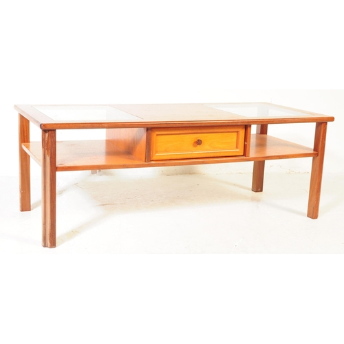 614 - British Modern Design - A mid 20th century teak coffee table. The table having central teak top flan... 