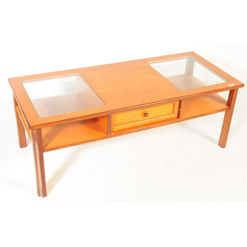 614 - British Modern Design - A mid 20th century teak coffee table. The table having central teak top flan... 