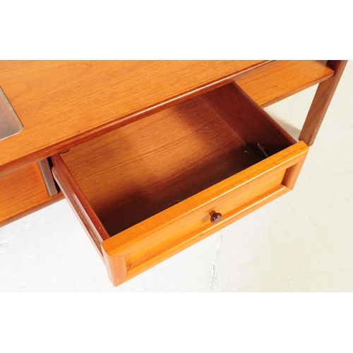 614 - British Modern Design - A mid 20th century teak coffee table. The table having central teak top flan... 
